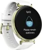 A smartwatch with a white strap and gold accents is shown against a white background. The watch face displays a SpO2 measurement interface with a droplet icon and the text 'Please remain stationary'. Voir les images du produit