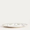 A white plate with a green floral pattern is shown on a white background. Náhľad obrázku produktu