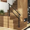 A modern staircase with wooden steps and a black metal handrail. Podgląd zdjęcia produktu