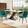 A dining room set with a marble-top table and four green velvet chairs, set against a large window with a view of trees. Podgląd zdjęcia produktu