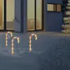 Christmas candy cane lights in the snow outside a building. Voir les images du produit