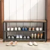 A shoe rack with shoes on display, placed on a rug in front of a wall. Podgląd zdjęcia produktu