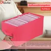 A person is holding a pink storage box filled with folded light pink items. Produktbild-Vorschau