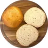 Three burger buns on a wooden cutting board. Produktbild-Vorschau