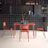 A table and four chairs set up in a modern bar or restaurant setting with black tiled walls. Anteprima dell’immagine prodotto