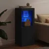 A black sideboard with blue LED lighting is shown in a living room setting next to a sofa and a plant. Anteprima dell’immagine prodotto