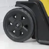 A close-up of a black wheel with a black rim on a yellow and black rolling tool chest. Voir les images du produit