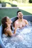 A couple relaxing in an inflatable hot tub outdoors. Náhled obrázku produktu
