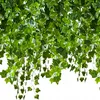 A close-up view of artificial ivy garlands hanging down against a white background. Produktbild-Vorschau