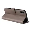 A gray flip case for a smartphone is shown open, revealing the phone inside. The case has a textured finish and a small decorative pattern on the front flap. Produktbild-Vorschau