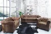 A living room scene with a sofa set, a bookshelf, and large windows. Náhled obrázku produktu