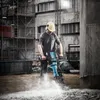 A construction worker using a demolition hammer on a concrete surface. Anteprima dell’immagine prodotto