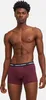 A man wearing burgundy boxer shorts with a navy blue waistband. Produktbild-Vorschau