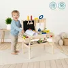 A young child is happily playing with a wooden toy workbench and tools. Náhled obrázku produktu