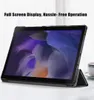 A tablet in a black case is shown on a white surface, with a blurred background of curtains and a cup and saucer on the right. Produktbild-Vorschau