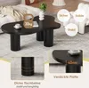 A black coffee table with a unique cloud shape, shown in a living room setting with decorative elements and text overlays highlighting its features. Voir les images du produit