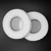 Two white, circular headphone ear pads are shown on a black background. Náhled obrázku produktu