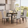 A dining set with chairs and a table in a modern kitchen with a large window overlooking a garden. Produktbild-Vorschau