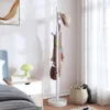 A bedroom scene with a coat rack, nightstand, and bed. Náhled obrázku produktu