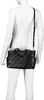 A black quilted handbag displayed on a white mannequin. Náhľad obrázku produktu