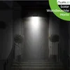 A dark outdoor staircase leading to a doorway, illuminated by a bright solar wall light above the door. Two potted plants flank the entrance. Produktbild-Vorschau