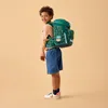 A young boy wearing a backpack and smiling. Anteprima dell’immagine prodotto