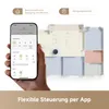 A hand holding a smartphone displaying a robot vacuum app interface, with a floor plan of a house in the background showing a robot vacuum cleaner. Produktbild-Vorschau