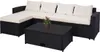 A black poly-rattan sectional sofa with cream cushions and a matching coffee table, set against a white background. Anteprima dell’immagine prodotto