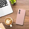 A pink phone case, a laptop, and a cup of coffee are arranged on a wooden desk. Produktbild-Vorschau