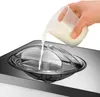 Eine Hand schüttetMilch aus einer kleinen Glasschale in die Unold Eismaschine Gusto 2  Produktbild-Vorschau