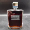 A perfume bottle with a silver cap and a dark brown liquid inside, placed on a gray surface against a black background. Náhled obrázku produktu