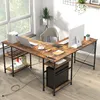 An L-shaped desk with a laptop, computer monitor, tablet, and other office supplies in a home office setting. Anteprima dell’immagine prodotto