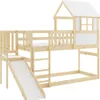 A wooden bunk bed with a slide and a small house-like structure on top, set against a white background. Produktbild-Vorschau