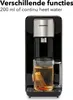 A black hot water dispenser with a glass mug of tea brewing beneath it. Produktbild-Vorschau