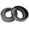 Two black headphone ear pads and their plastic mounting frames are shown against a white background. Produktbild-Vorschau