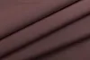 A close-up view of folded brown fabric, likely a curtain or textile. Produktbild-Vorschau
