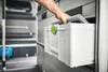 A hand is pulling a white toolbox out of a storage unit inside a vehicle. Anteprima dell’immagine prodotto