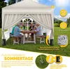 A family enjoying a meal under a beige pop-up gazebo in a grassy garden. Voir les images du produit