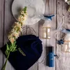 A flat lay arrangement of a Neno electric breast pump, accessories, and decorative flowers on a wooden background. Podgląd zdjęcia produktu