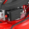 A close-up view of the engine of a red lawnmower. Produktbild-Vorschau