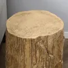 A close-up shot of a tree stump-shaped side table. Produktbild-Vorschau