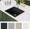 A black granite kitchen sink is shown on a white countertop, with green cabinets below. Several color swatches are displayed at the bottom of the image. Náhled obrázku produktu