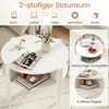 A white round coffee table with storage, shown in a living room setting with decorative items and books. Produktbild-Vorschau