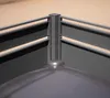 A close-up view of the corner of a gray metal trash can enclosure, showing the post and railing. Náhled obrázku produktu