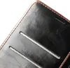 A close-up view of a dark brown and black leather flip phone case. Produktbild-Vorschau