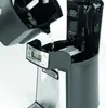 A coffee maker is being filled with water from its reservoir. Produktbild-Vorschau