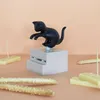 A black cat figurine on a gray dispenser, surrounded by cheese and breadsticks. Podgląd zdjęcia produktu