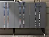 A close-up view of a modern anthracite and silver cabinet with reflective vertical accents. Anteprima dell’immagine prodotto