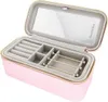 An open pink jewelry box with compartments and a mirror inside. Voir les images du produit
