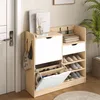 A shoe cabinet with multiple shelves and drawers, placed next to a door and a plant. Voir les images du produit